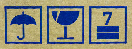 Fine image close-up of fragile symbol on cardboard.の写真素材