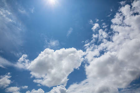 Blue sky with clouds and sun.の写真素材