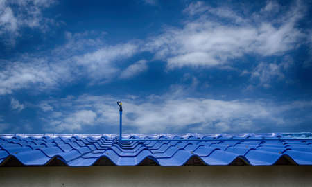 Water springer on roof and sky with cloudsの写真素材