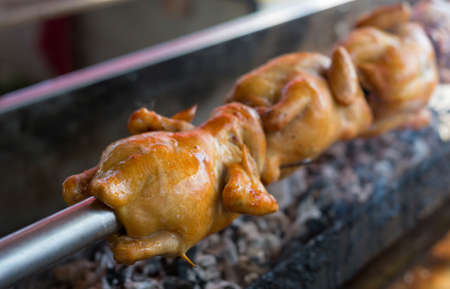 close up Rotating machine are grilled chickenの写真素材
