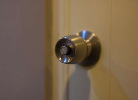 close up of metal handle on a wooden door,golden door knob.の写真素材