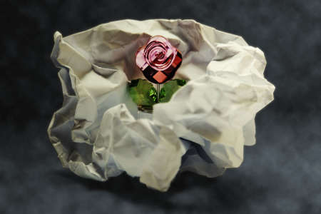 Glass rose in crumpled paper 