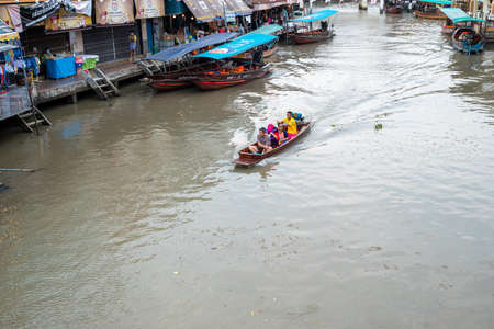 Amphawa Floating Market, Thailand. Amphawa Canal is occupied by vendors who pack their boats with...