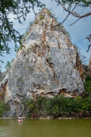 Rock mountain scene and blue sky background. Green botany below the mountain.の写真素材