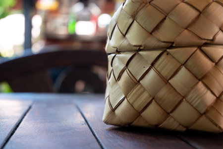 Bamboo wicker sticky rice basket called "Kratip" in the northeastern province, Thailand. Asian sticky rice container. Traditional sticky rice baskets are used in local houses and restaurants.の写真素材