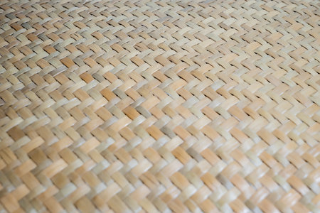 A specific focused point of abstract wicker texture of bamboo weaver which made of pieces of bamboo tiles weaved together. Bamboo wicker basket texture.の写真素材