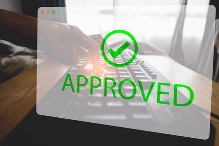 Asian woman hand tapping enter button for approving requests at home. Black old keyboard and visualized transparent virtual window displaying approval status. Conceptual of business at home.の写真素材