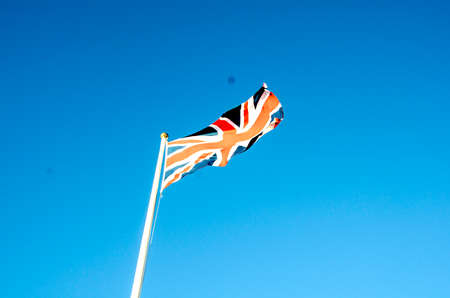 English flag in sunny autumn day against a blue skyの写真素材