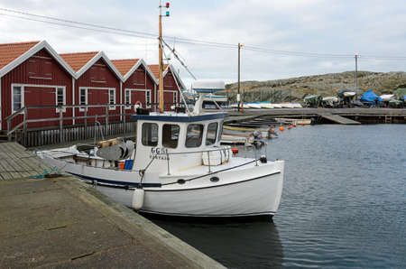 lonely small fishing boat in the harbor on a winter KlÃ¤desholmenのeditorial素材