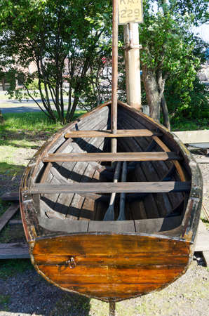 one old rowboat made of wood it stand on land in the harbourの写真素材