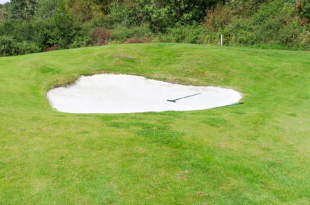 one bunker on the golf course almost near the forestの写真素材