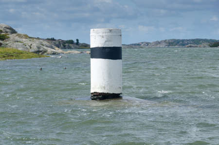 one navigation mark in the water to help to drive the boat safeの写真素材