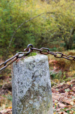 one stone with a rusty chain to next stoneの写真素材