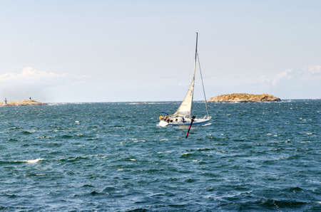 sailing a blowing day on westcoast in sweden one lonely boatの写真素材