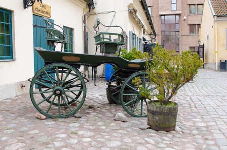 one old horse wagon standing outside the house and the old cafeのeditorial素材