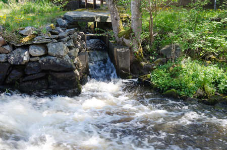 the water in river begins to be foam when its rushing downの写真素材