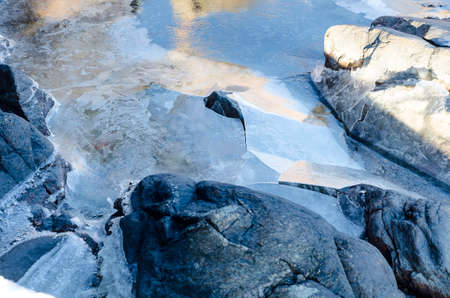 some ice on the water and rocks and stoneの写真素材