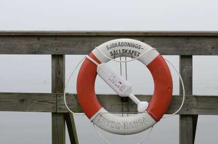 one lifebuoy place on the pier in the harbourの写真素材