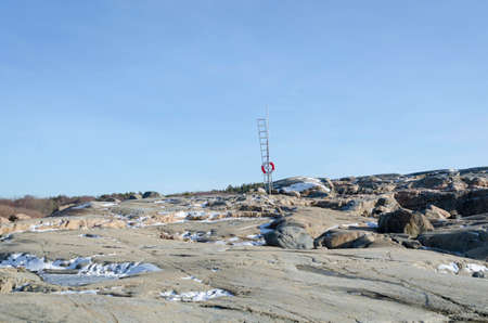 one sunny day on the swedish westcoast some snow on the rockの写真素材