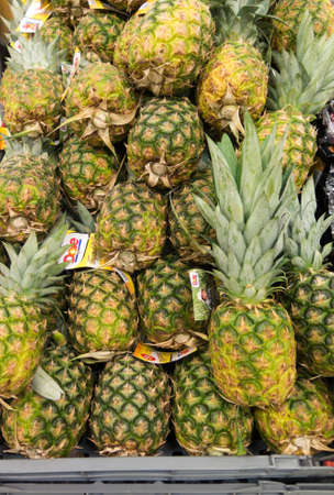many pineapple for sale on a big supermarketの写真素材