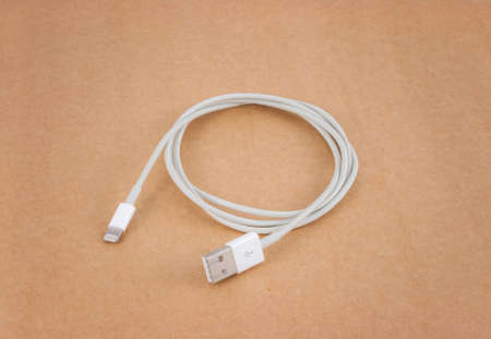 white smartphone charger over brown paper