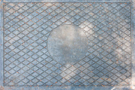 old steel background with weave pattern and circle at centerの写真素材