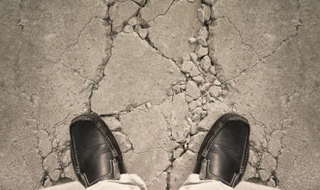 a man standing on crack ground, for risk conceptの写真素材