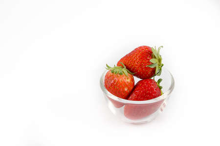 red strawberry in chalice on white backgroundの写真素材