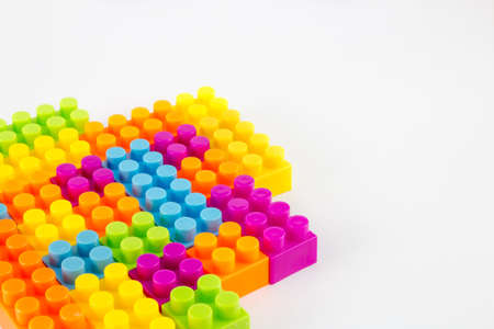 Small pile of colorful childrens building bricks on white backgroundの写真素材