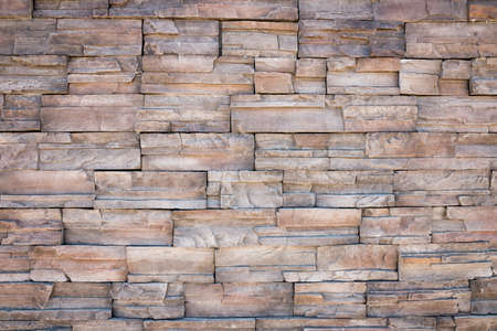old wall stone tiles background with earth tone