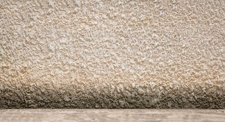 rough concrete wall and concrete floor with stain of lichen, background