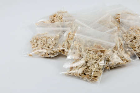 dry chinese plum in plastic pack on white backgroundの写真素材