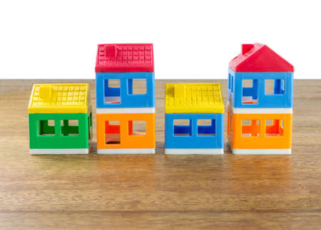 plastic house toys on arrange on wood tableの写真素材