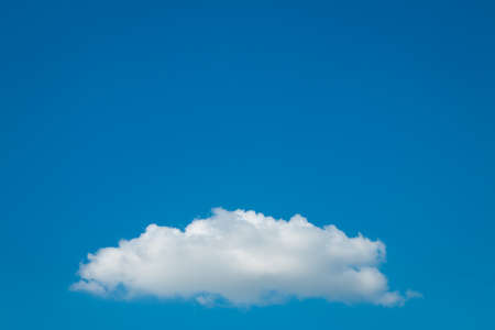 one cloud on clean blue sky, abstract backgroundの写真素材