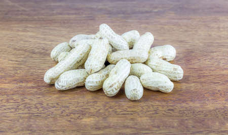 peanuts with shell on wood table