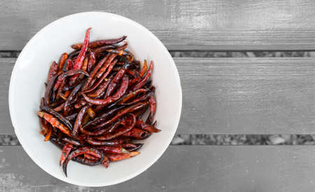 dry chilli roast in oil on white bowlの写真素材