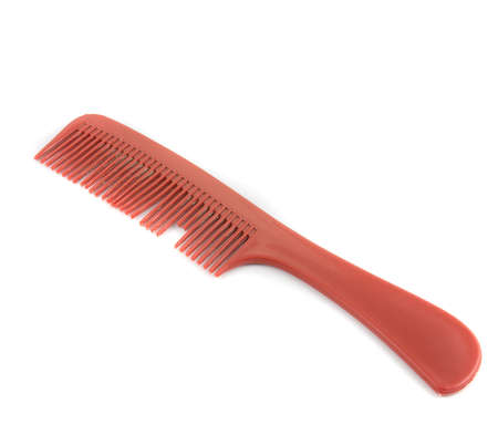 old and broken red comb on white backgroundの写真素材