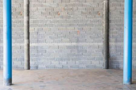 interior background, exposed concrete block wall and dirty floor, blue columnの写真素材