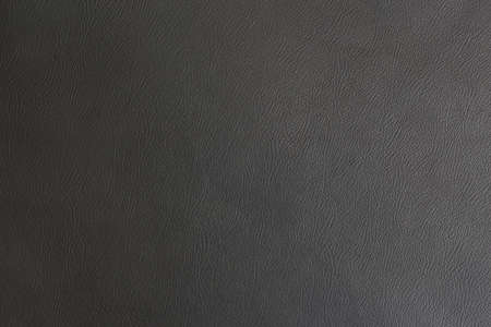 black leather abstract background with lighting from right sideの写真素材