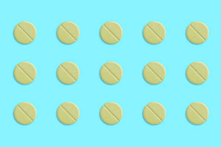green pills with drop shadow on blue background, vintage tone