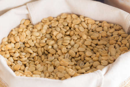 white coffee beans in bag, unroasted, selective focus