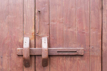 Old wooden door with wooden piece lock, abstract backgroundの写真素材