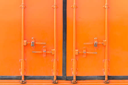 Orange container door and padlock, bolt locks, backgroundの写真素材