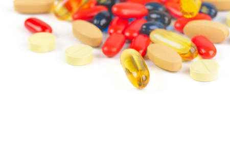 variety pills and vitamins colorful background