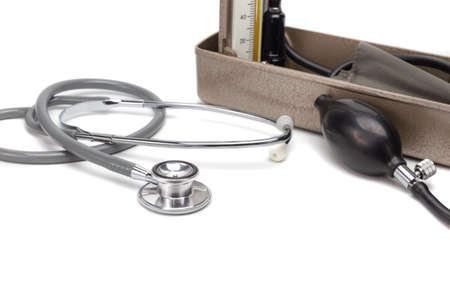 stethoscope and blurred blood pressure monitor on white background, health care and medical tool conceptの写真素材