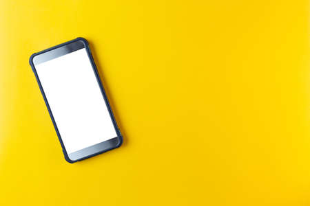 smart phone with white screen isolated on yellow backgroundの写真素材
