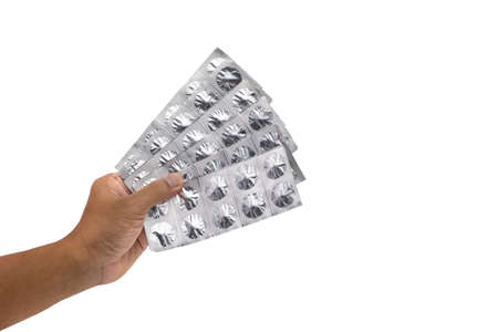 Hand holding pills of tablet isolated on white background with clipping path