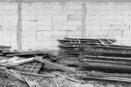 stack of scaffolds with lightweight brick wall background, black and white tone, industry construction conceptの写真素材