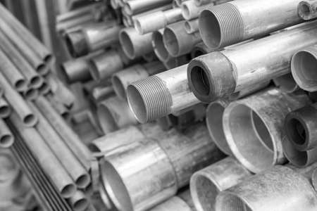 stack of steel electric conduit pipes, black and white tone, selective focus, industry concept backgroundの写真素材
