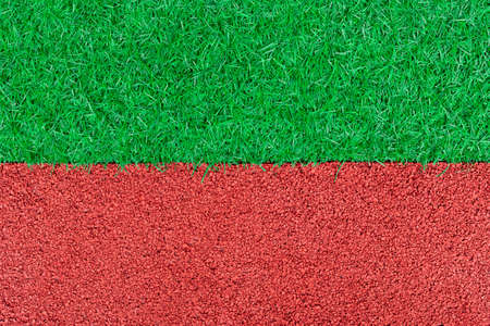 red rubber playground and artificial green grass, children activity abstract backgroundの写真素材